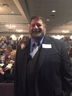 This image shows Dr. Guagliardo at the Cobb Chamber event recognizing him as Teacher of the Year from Life University.